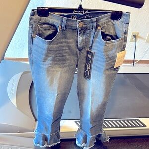 Cropped jeans.  Ankle length with flower shaped flared leg bottoms.